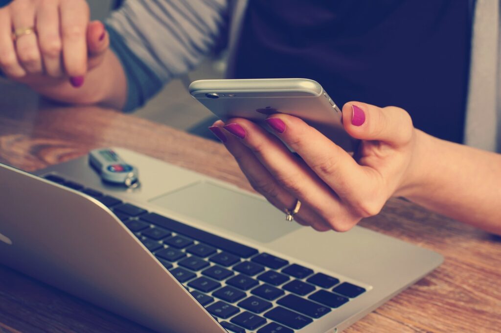 Woman working with a laptop and a mobile phone is receiving an abundant dose of EMFs